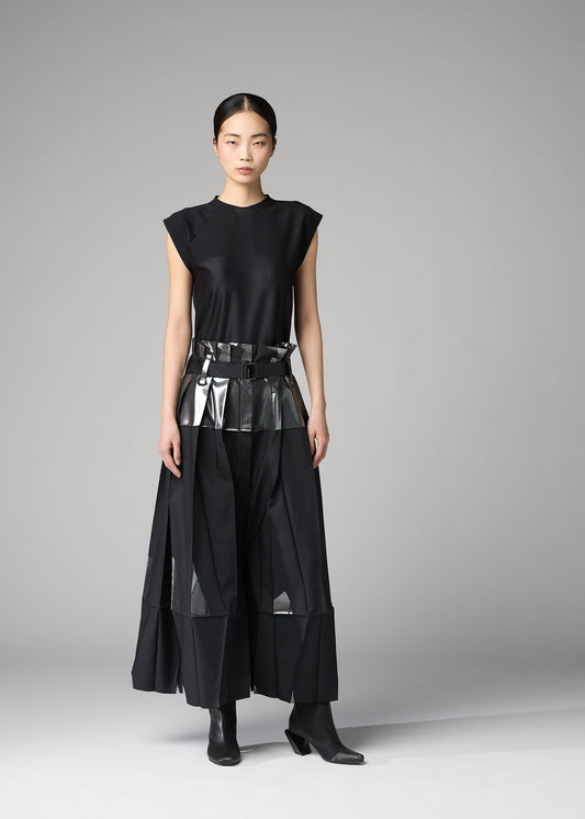 A model wears the 132 5. ISSEY MIYAKE No.3-1 trousers.