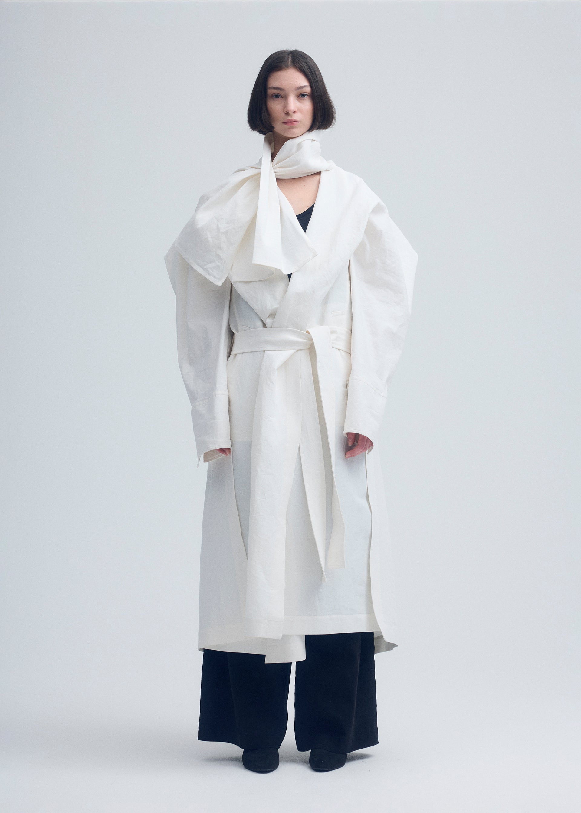 A model wears the ISSEY MIYAKE ENCLOTHE coat