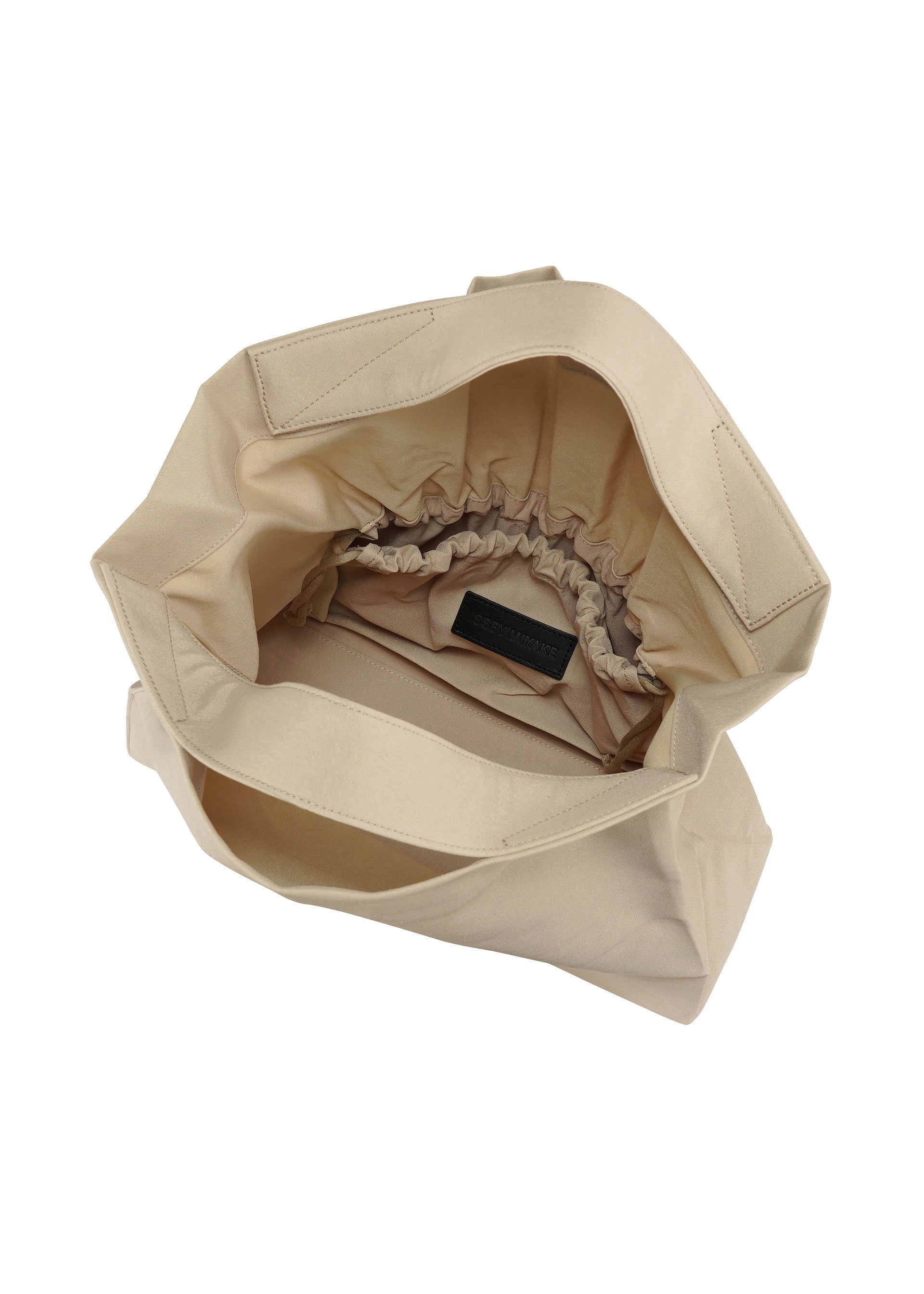 A detail shot of the ISSEY MIYAKE DRAWN AND PRESSED bag.