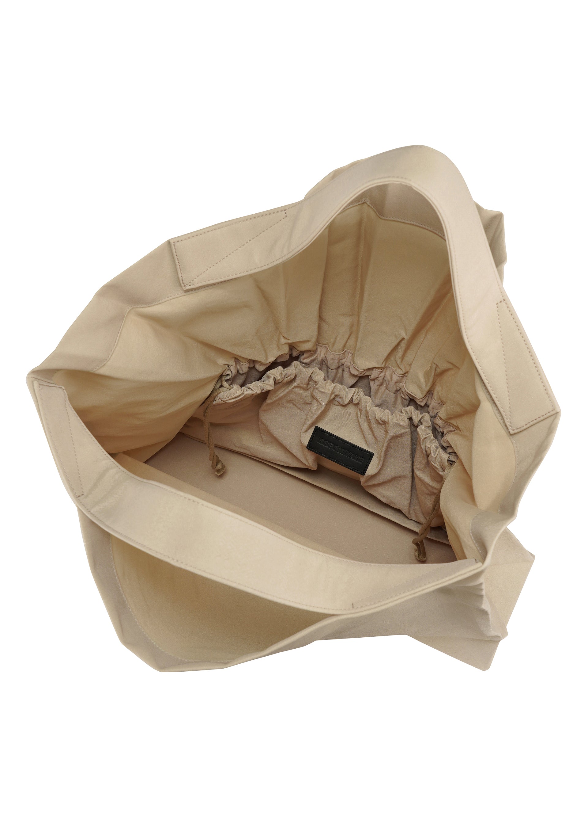 A detail shot of the ISSEY MIYAKE DRAWN AND PRESSED bag.