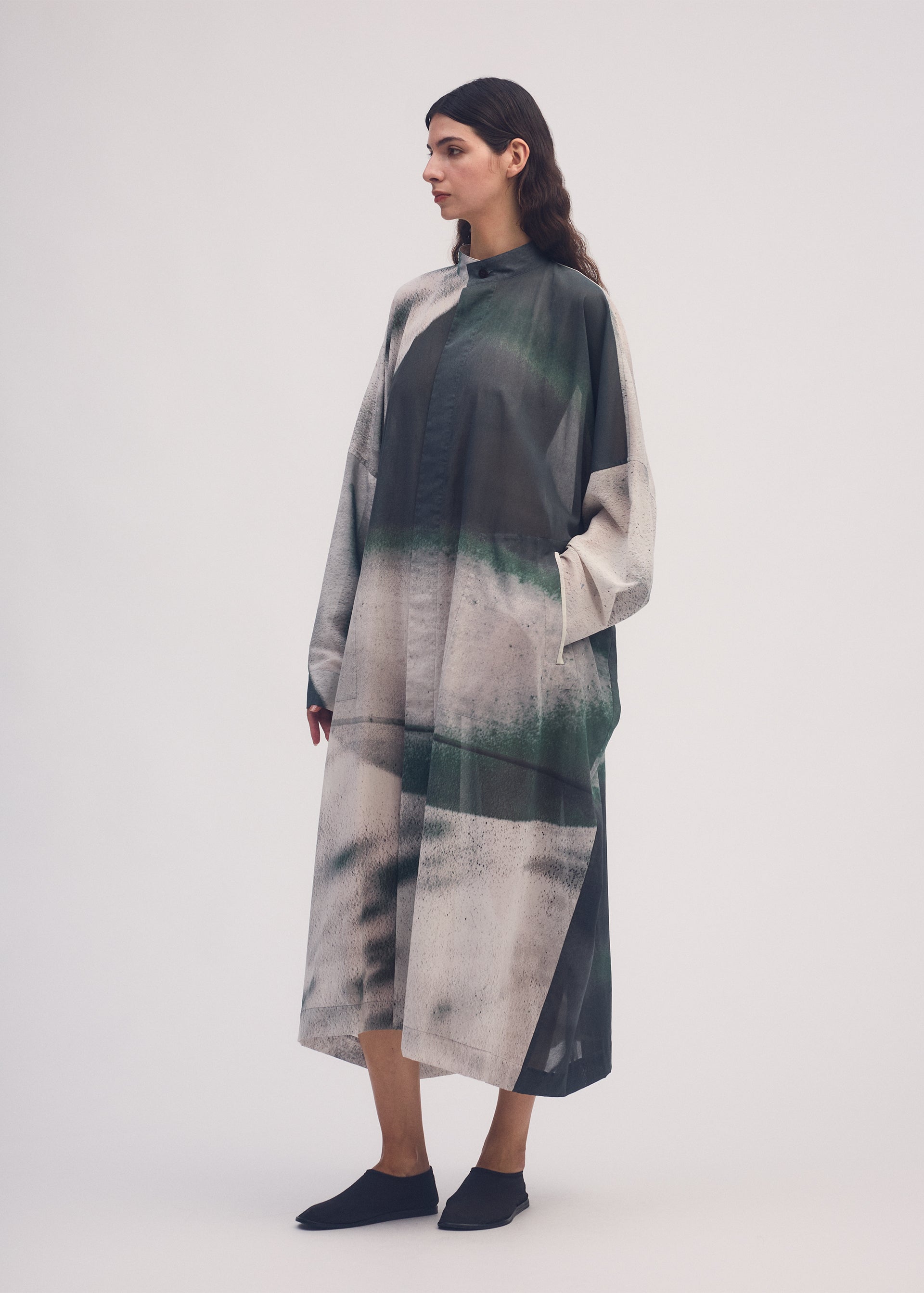 A model wears the ISSEY MIYAKE SHADOW STUDY coat.