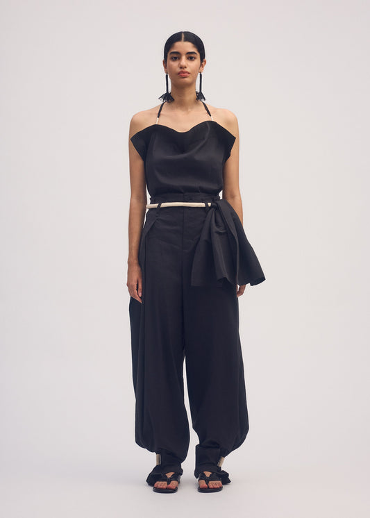 A model wears the ISSEY MIYAKE CLOTH AND CORD trousers.