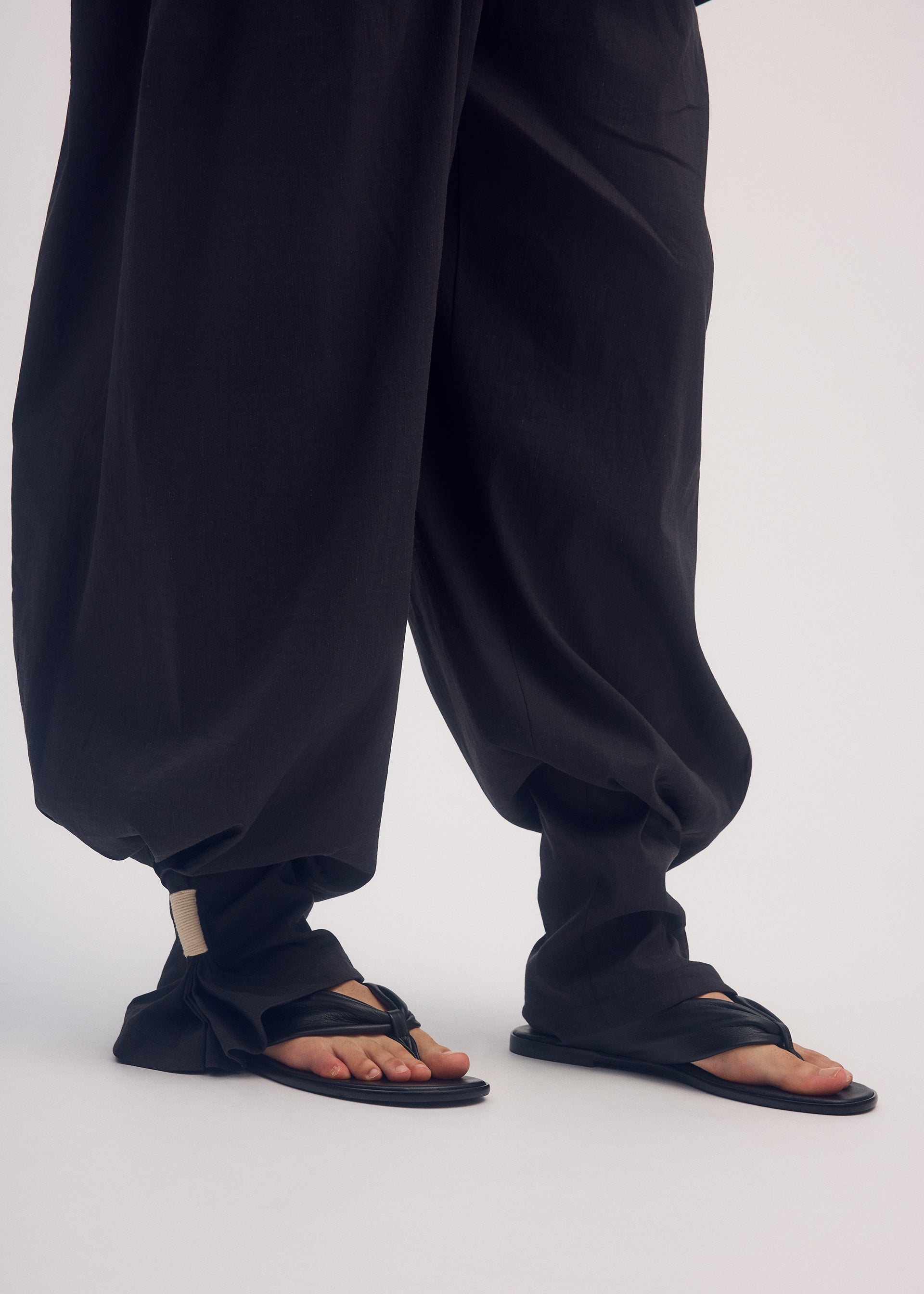 A model wears the ISSEY MIYAKE CLOTH AND CORD trousers.