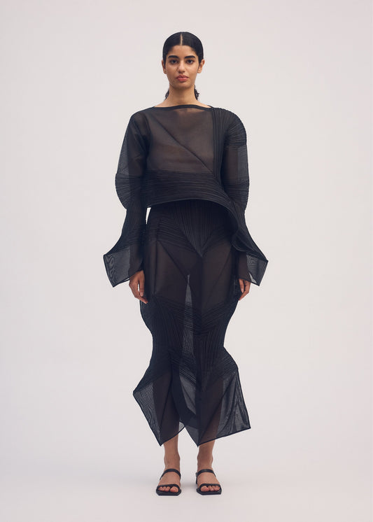 A model wears the ISSEY MIYAKE SHADE AND SHADED skirt.