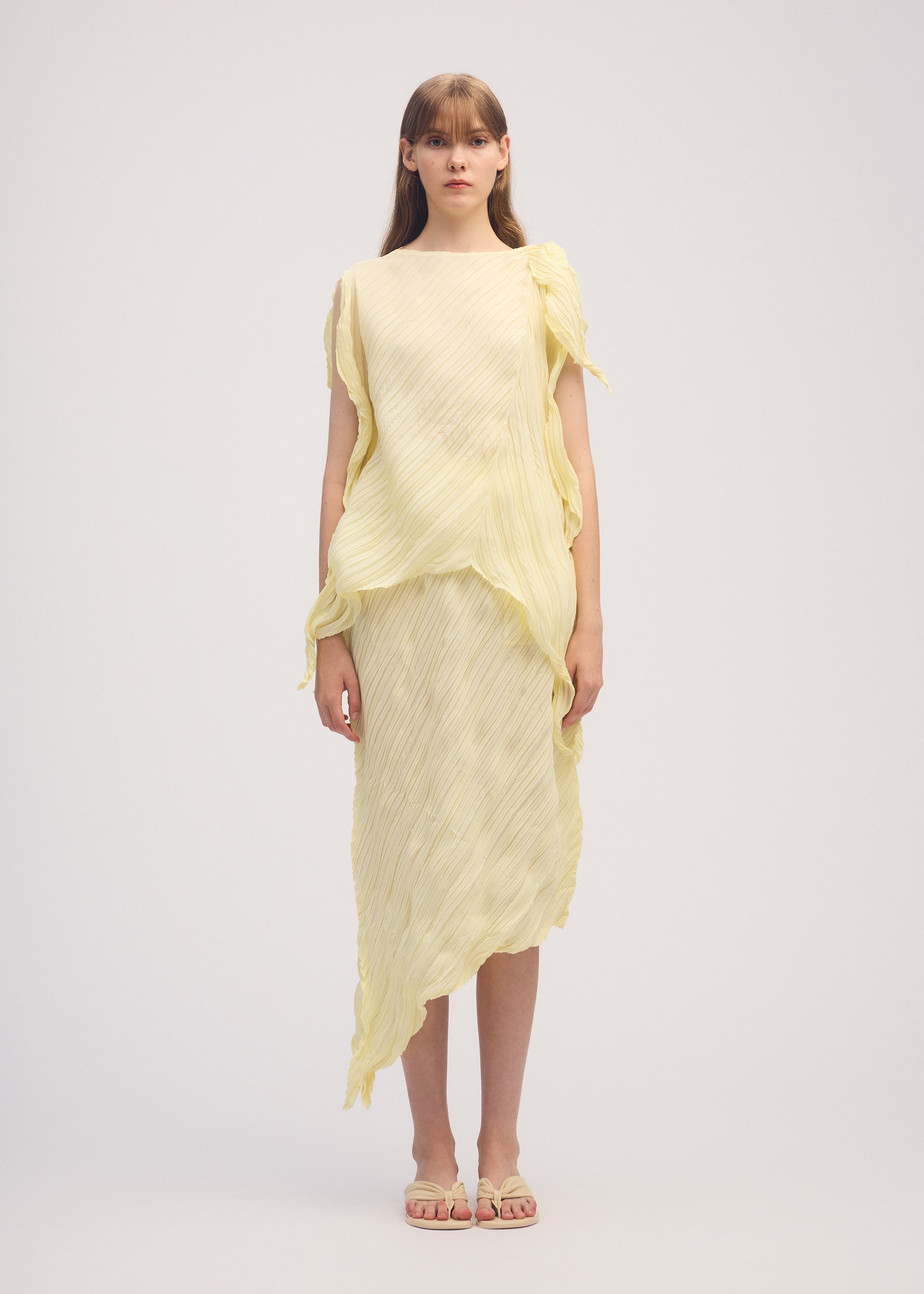 A model wears the ISSEY MIYAKE WRINKLED AND TWISTED skirt.