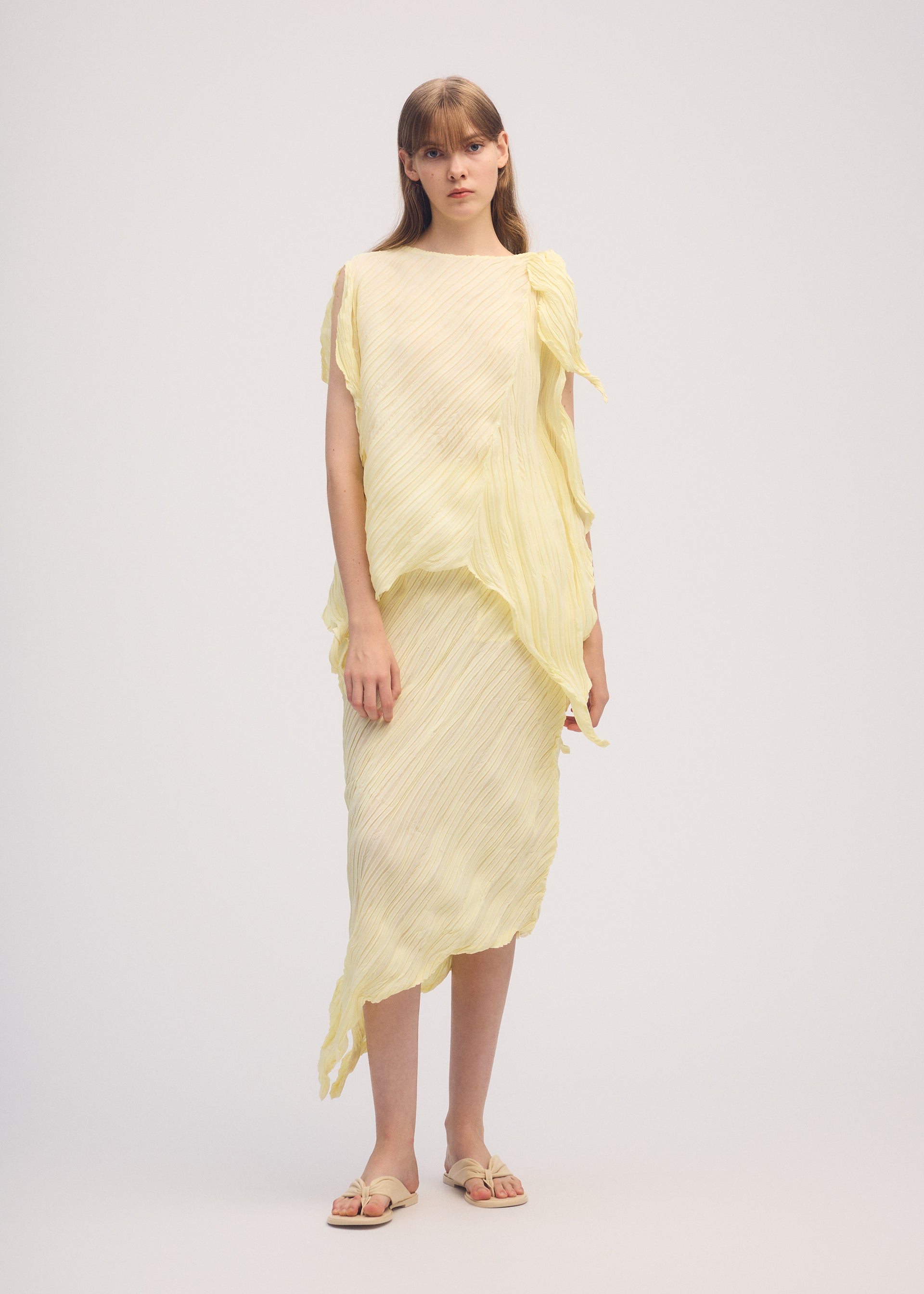 A model wears the ISSEY MIYAKE WRINKLED AND TWISTED skirt.