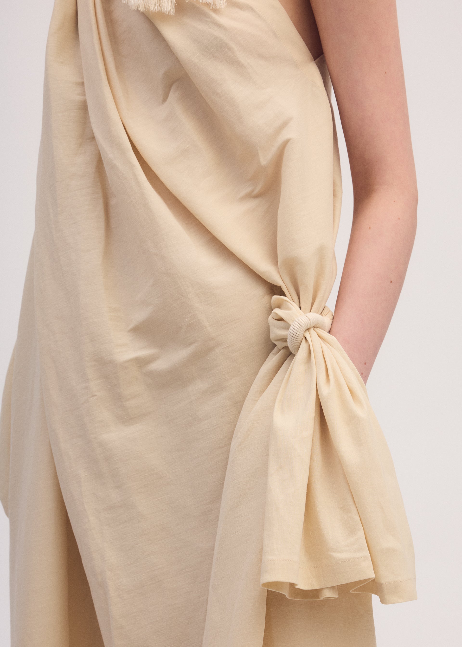 A model wears the ISSEY MIYAKE CLOTH AND CORD dress.