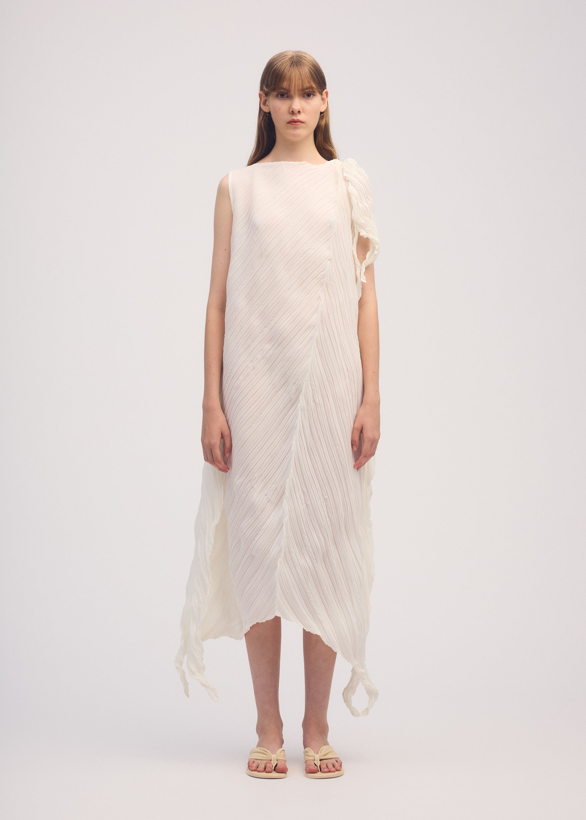 A model wears the ISSEY MIYAKE WRINKLED AND TWISTED dress.