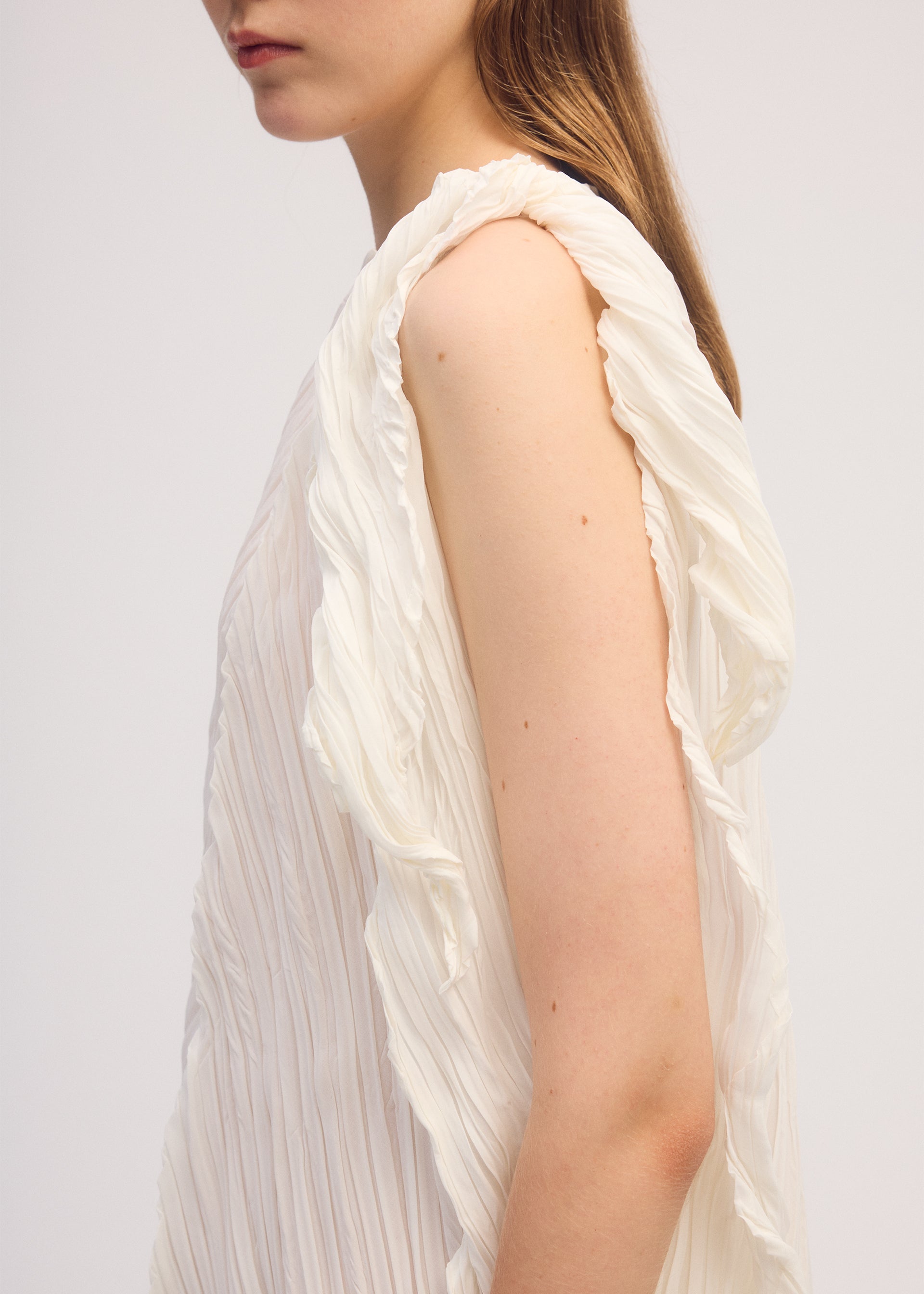 A model wears the ISSEY MIYAKE WRINKLED AND TWISTED dress.