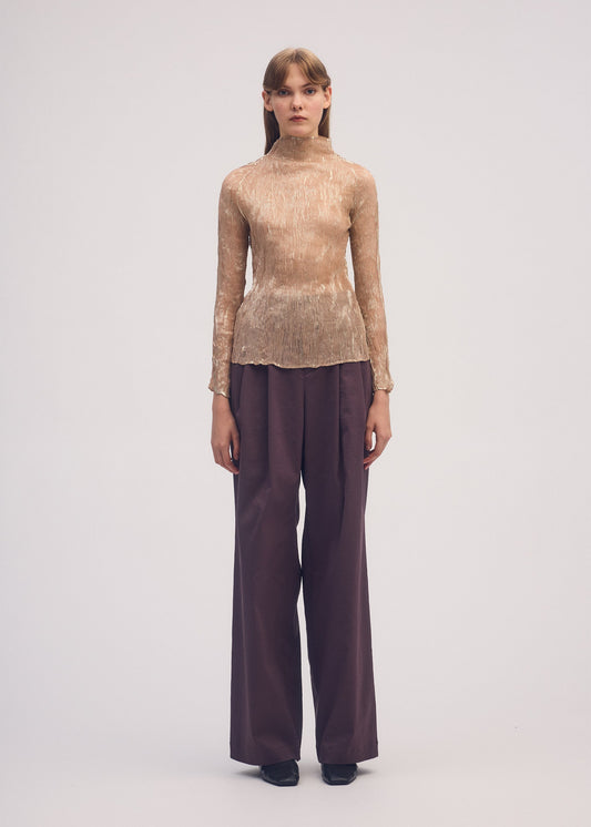 A model wears the ISSEY MIYAKE FOIL PRINT CHIFFON TWIST shirt.