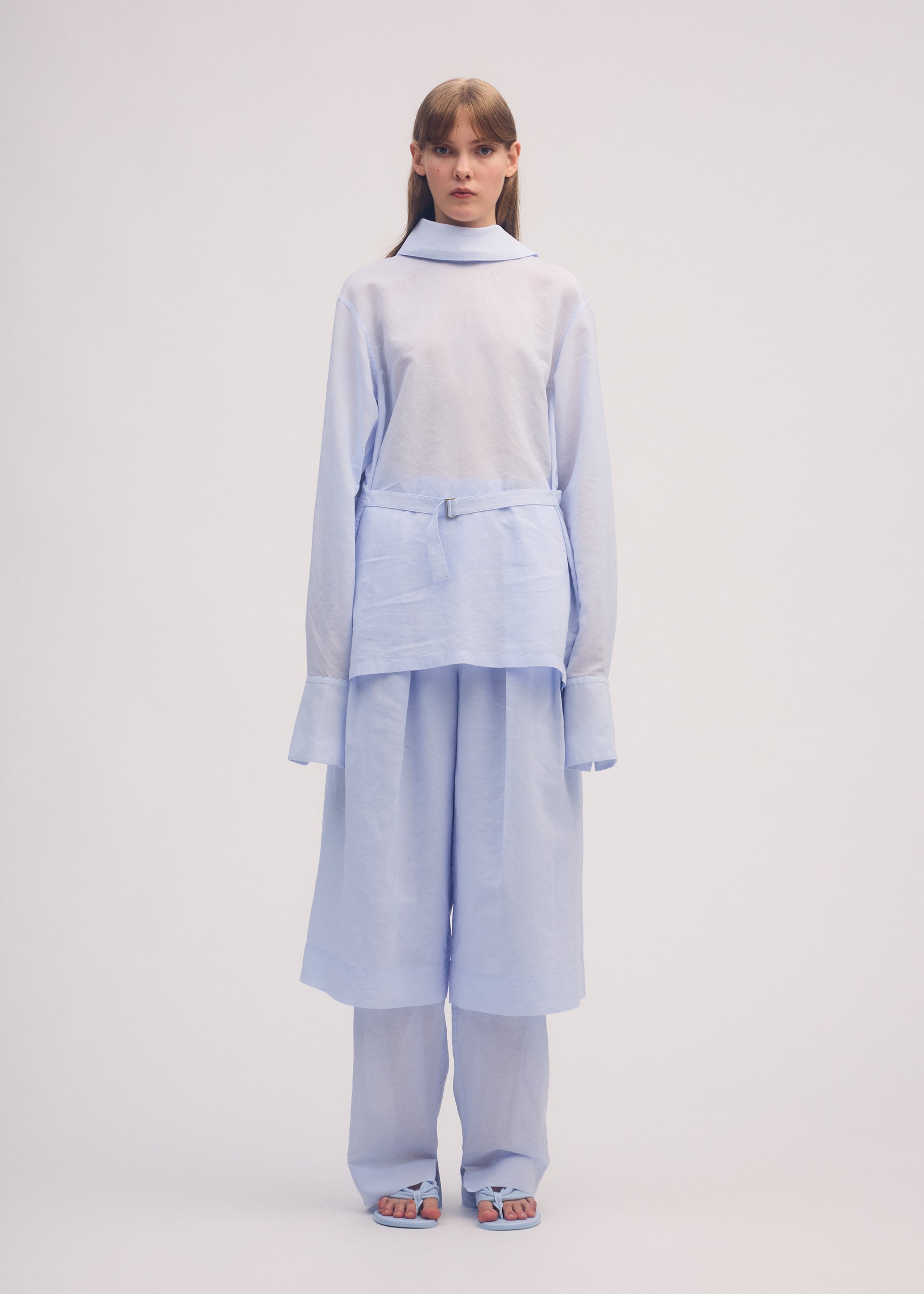 A model wears the ISSEY MIYAKE PAPER ESQUE U shirt.