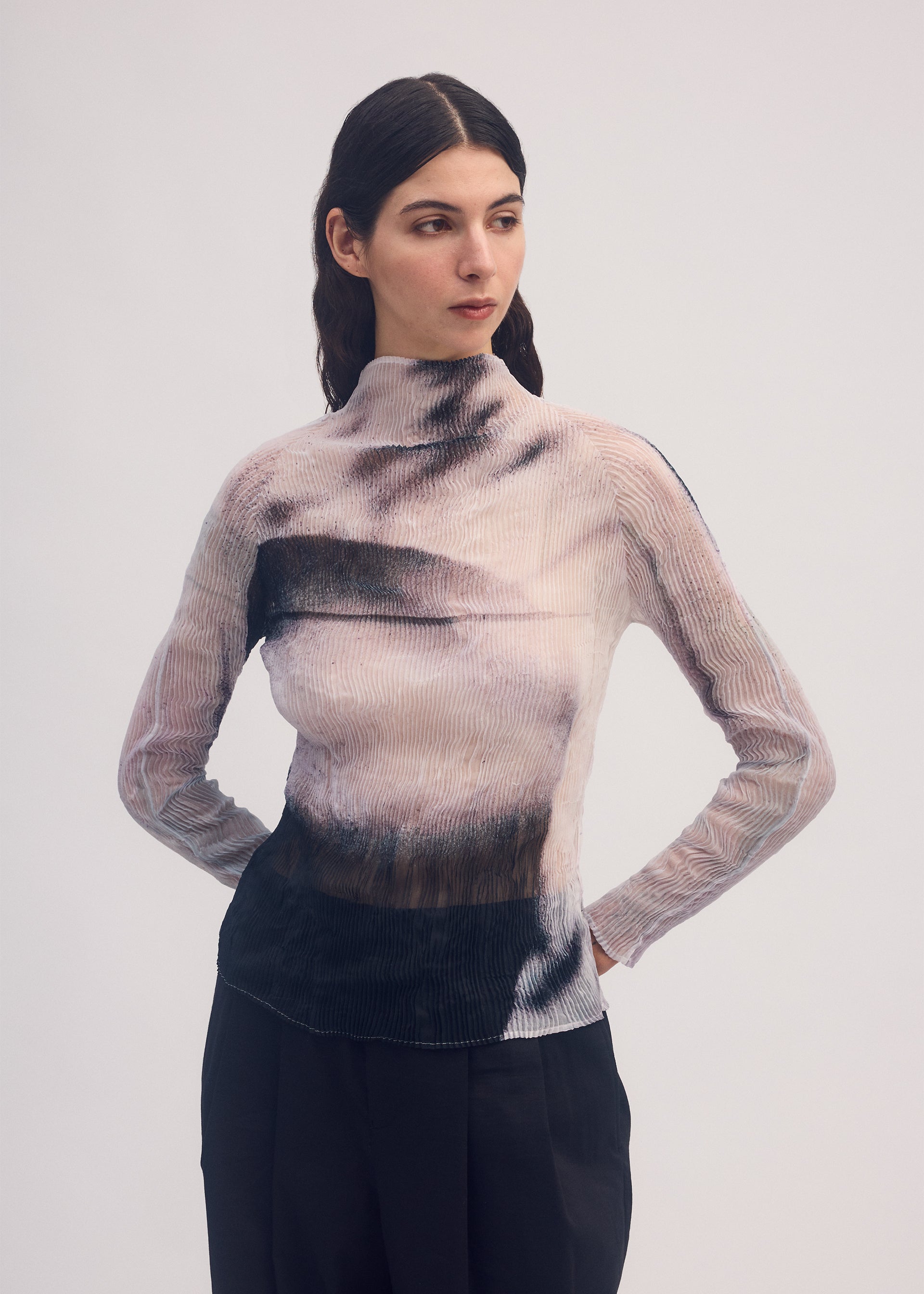 A model wears the ISSEY MIYAKE SHADOW STUDY CHIFFON TWIST shirt.