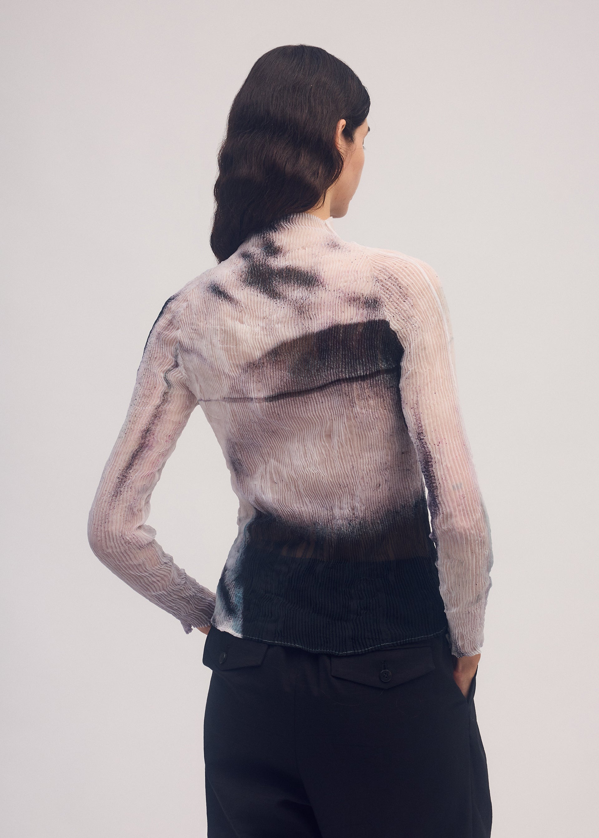 A model wears the ISSEY MIYAKE SHADOW STUDY CHIFFON TWIST shirt.
