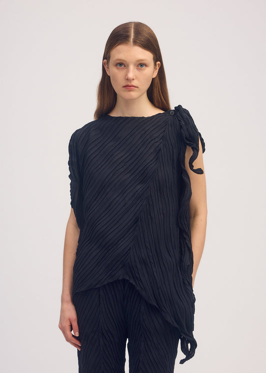 A model wears the ISSEY MIYAKE WRINKLED AND TWISTED shirt.