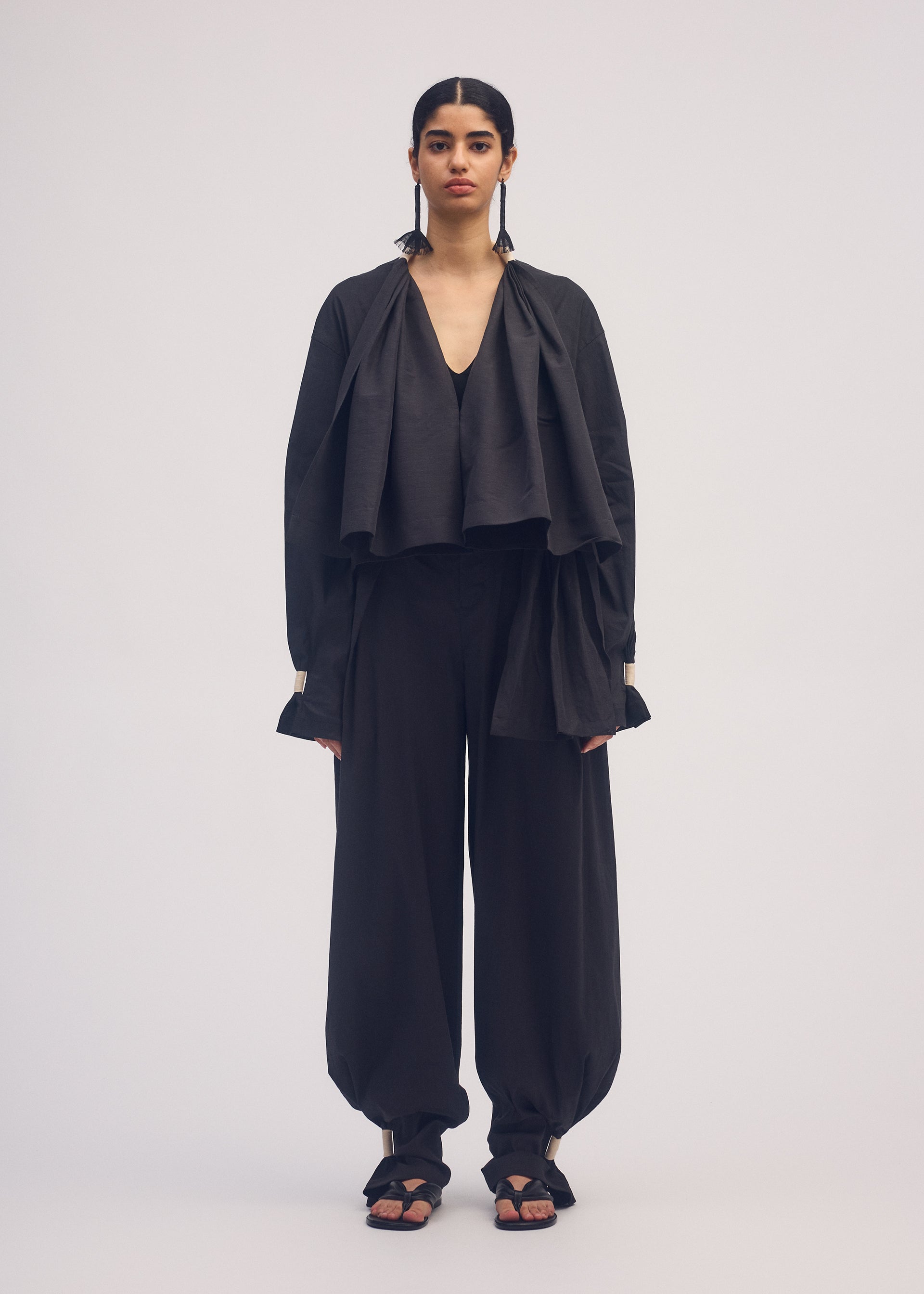 A model wears the ISSEY MIYAKE CLOTH AND CORD cardigan.