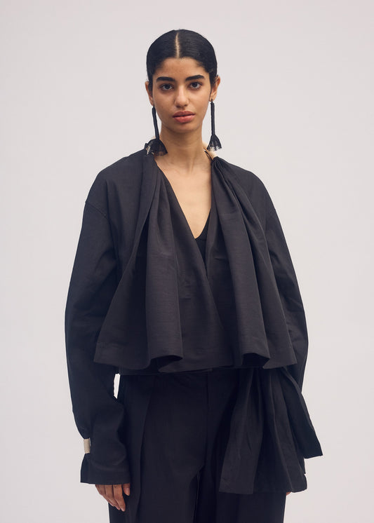 A model wears the ISSEY MIYAKE CLOTH AND CORD cardigan.