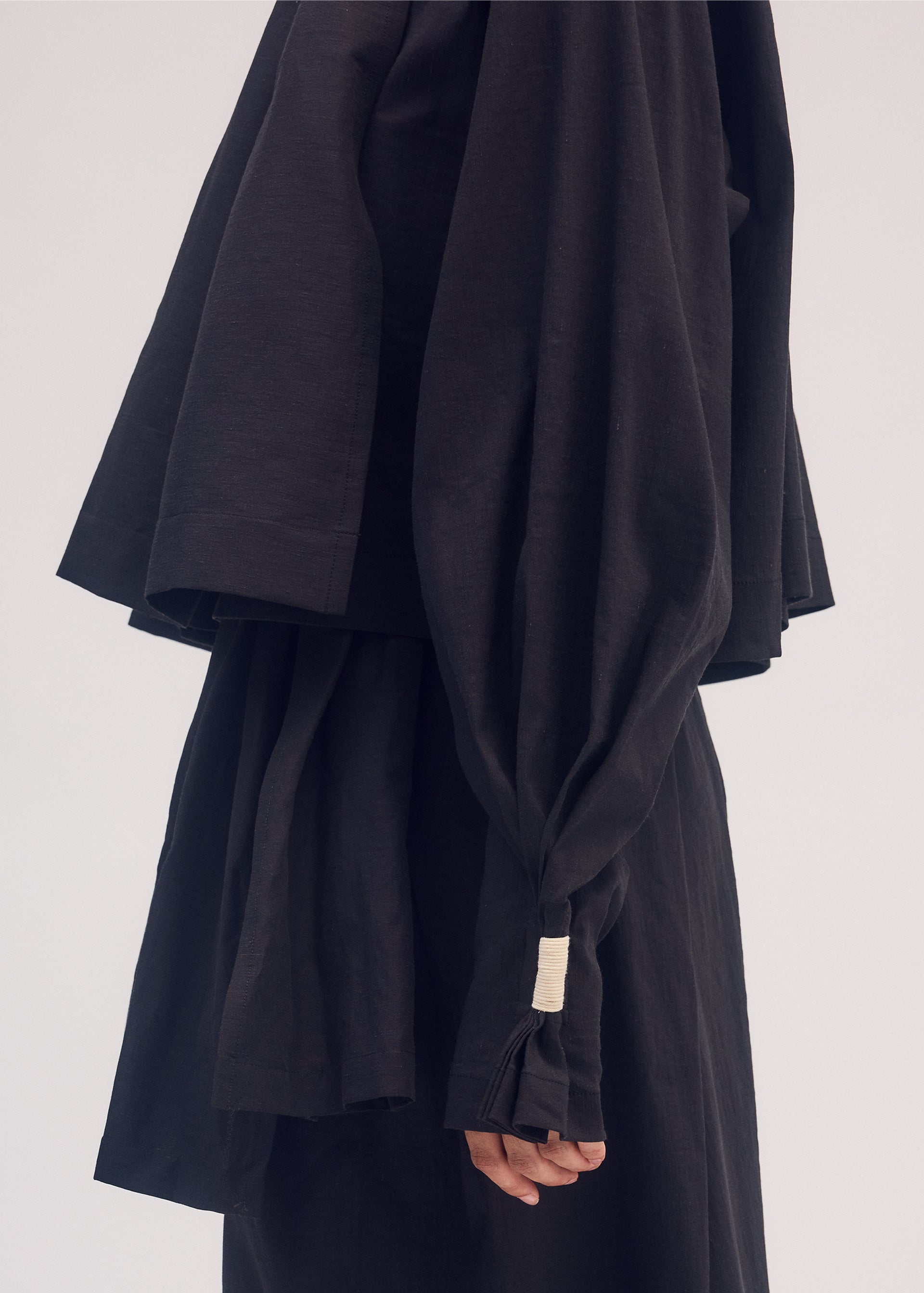 A model wears the ISSEY MIYAKE CLOTH AND CORD cardigan.