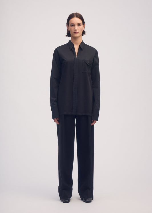 A model wears the ISSEY MIYAKE SIMPLE ENSEMBLE trousers.