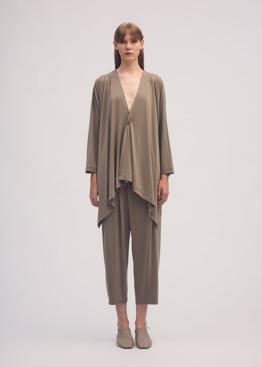 A model wears the ISSEY MIYAKE DRAPE JERSEY 56 cardigan.