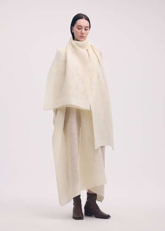 A model wears the ISSEY MIYAKE PANINI STOLE stole.