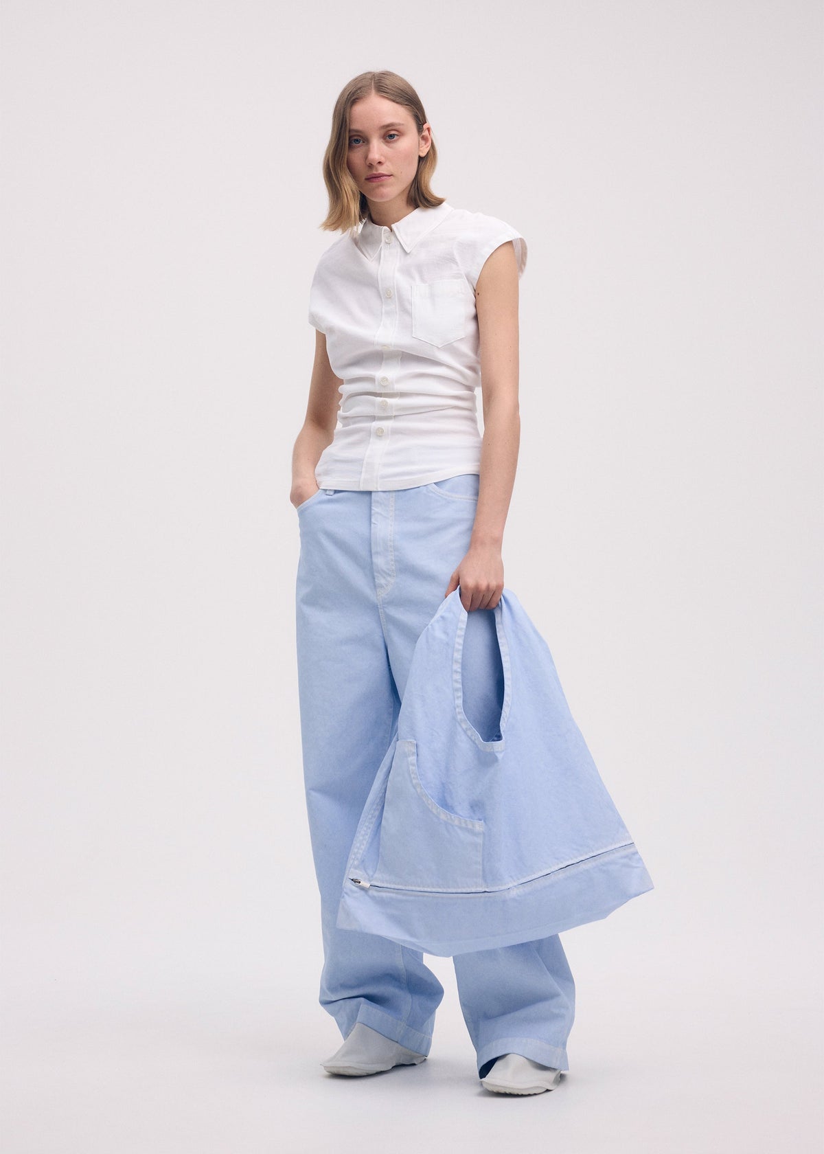 A model wears the ISSEY MIYAKE SCULPTURAL (BAG) bag.