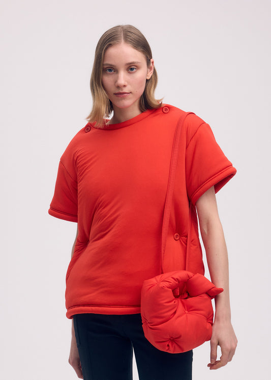 A model wears the ISSEY MIYAKE PUMPED BAG bag.