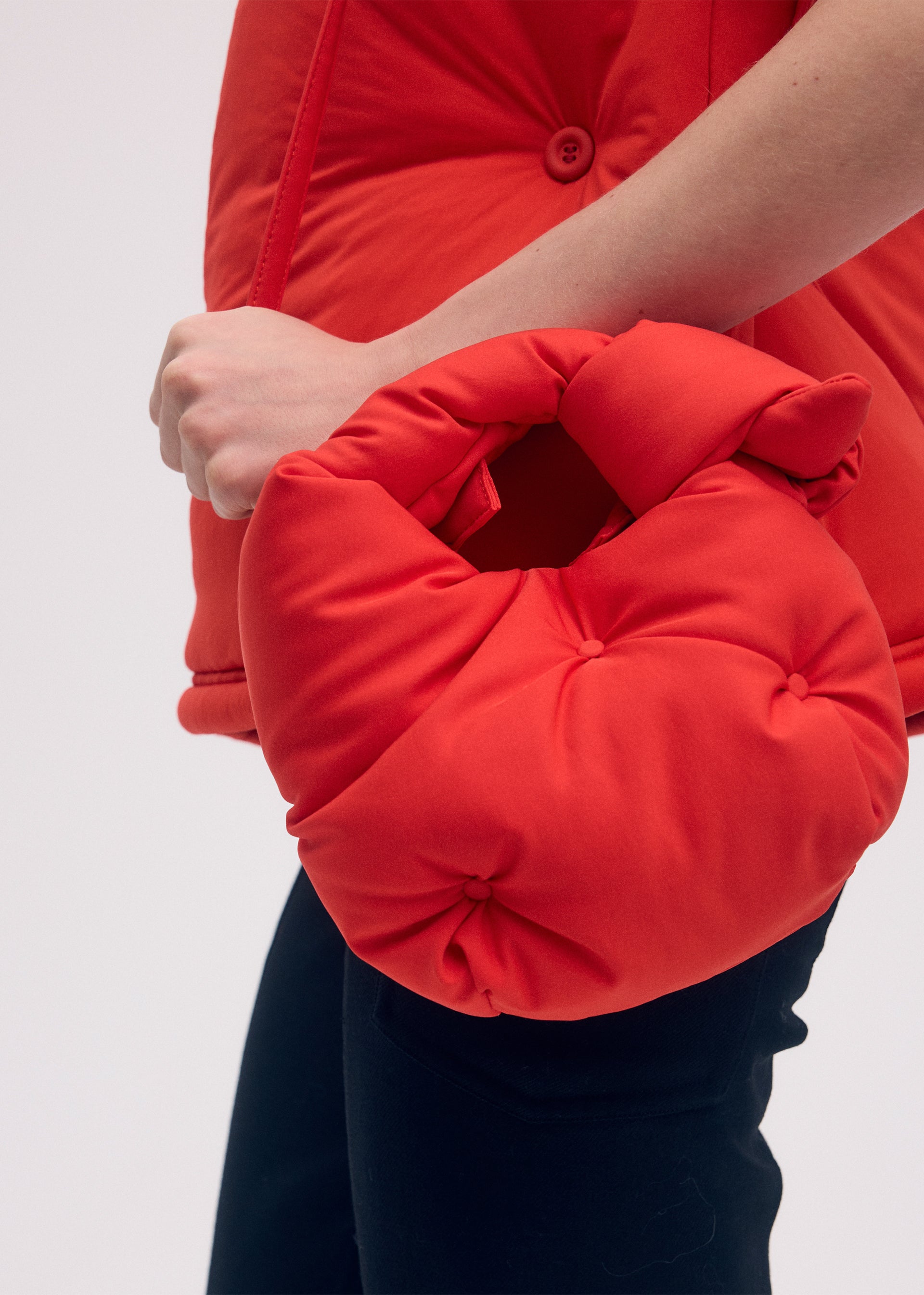 A model wears the ISSEY MIYAKE PUMPED BAG bag.