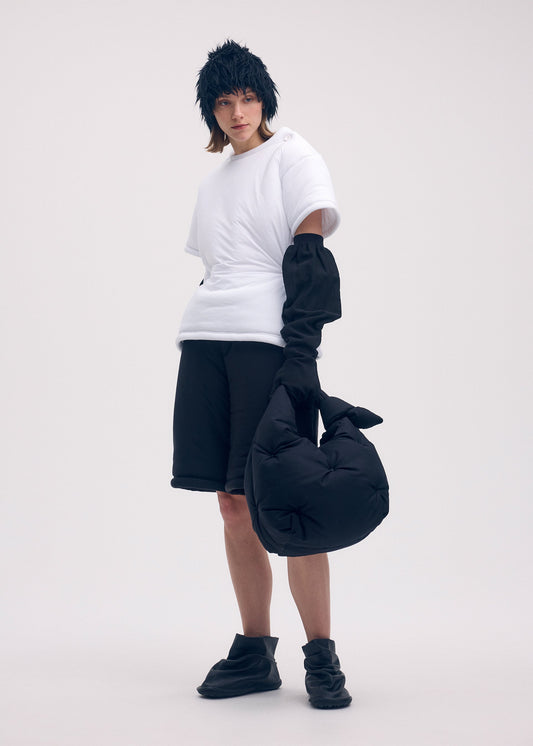 A model wears the ISSEY MIYAKE PUMPED BAG bag.