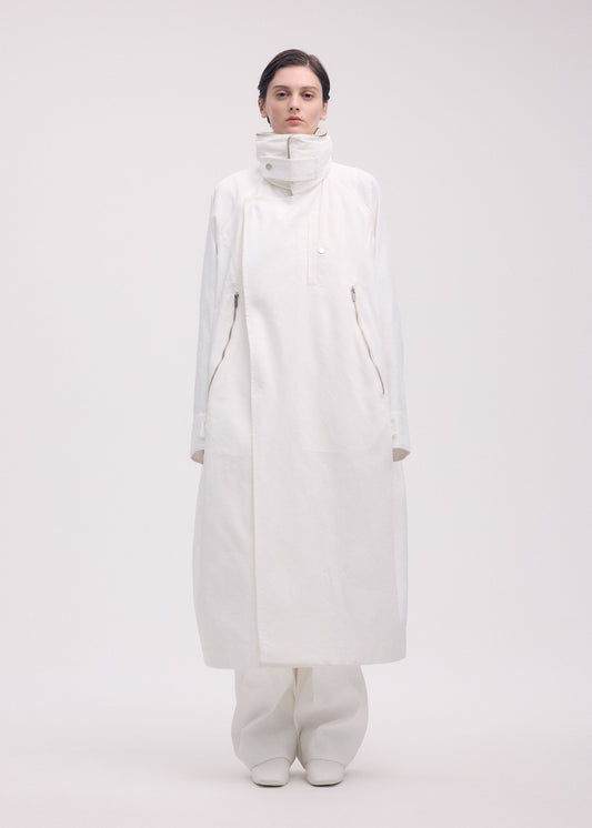 A model wears the ISSEY MIYAKE PEEKABOO coat.