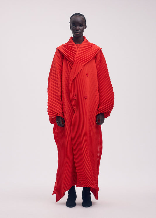 A model wears the ISSEY MIYAKE WAVE PLEATS coat.