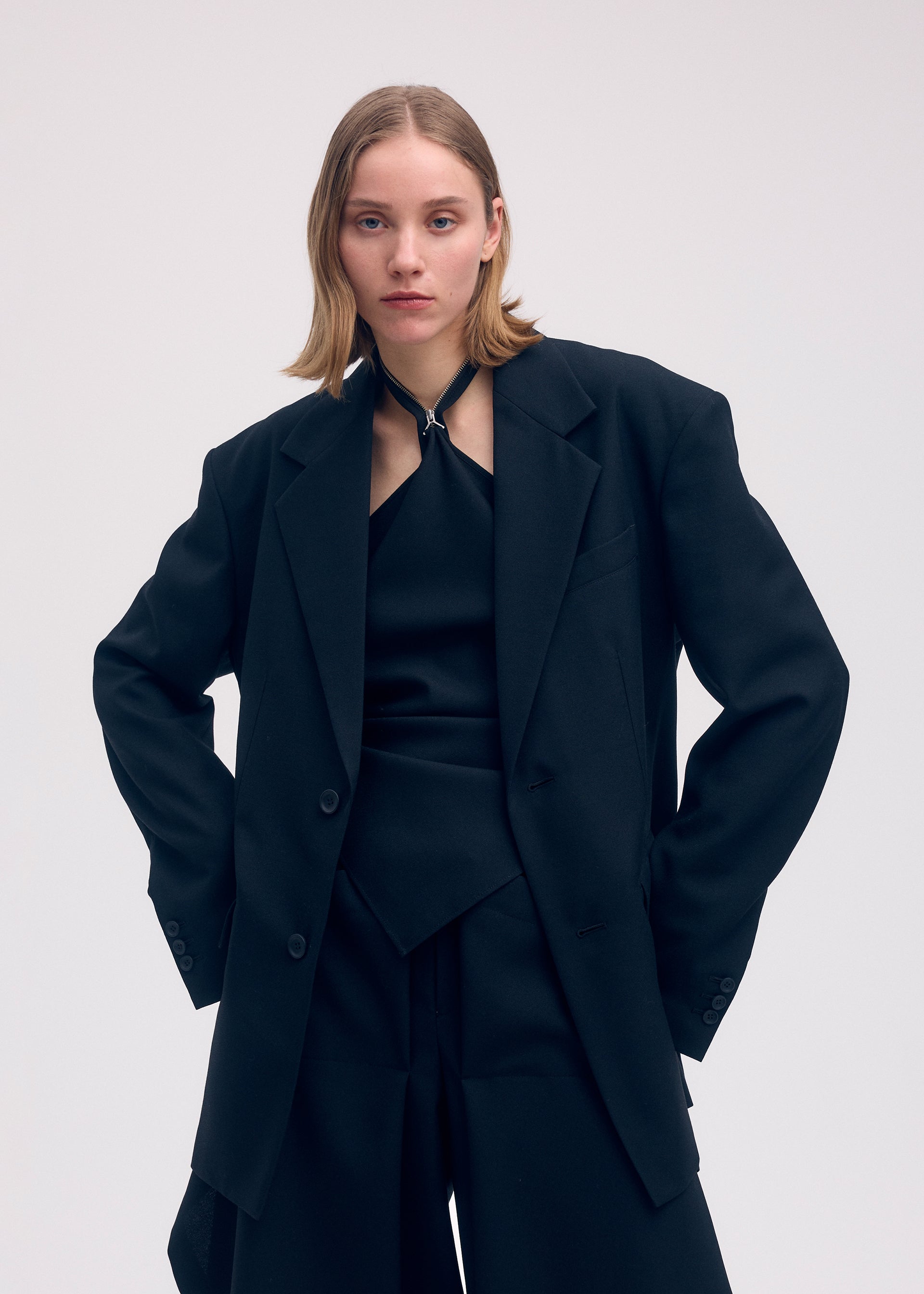 A model wears the ISSEY MIYAKE UNI FORM (WOOL) jacket.
