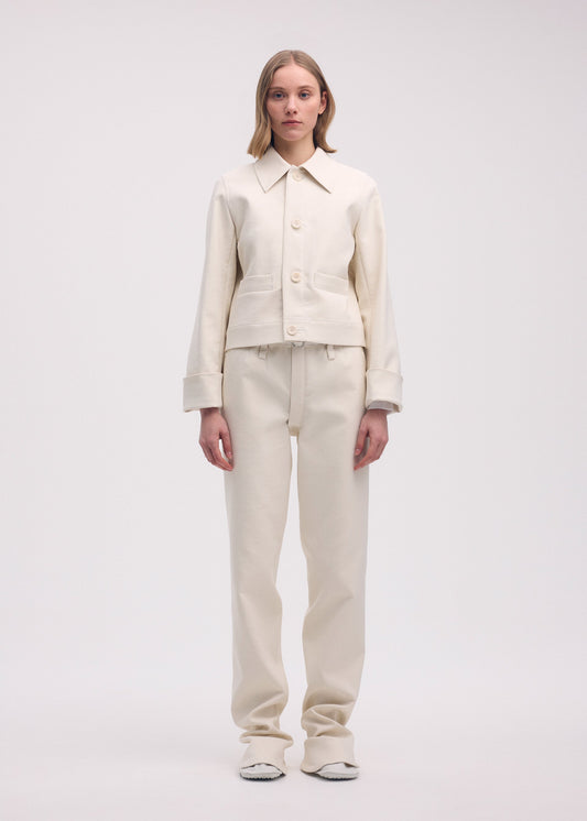 A model wears the ISSEY MIYAKE GYPSUM jacket.