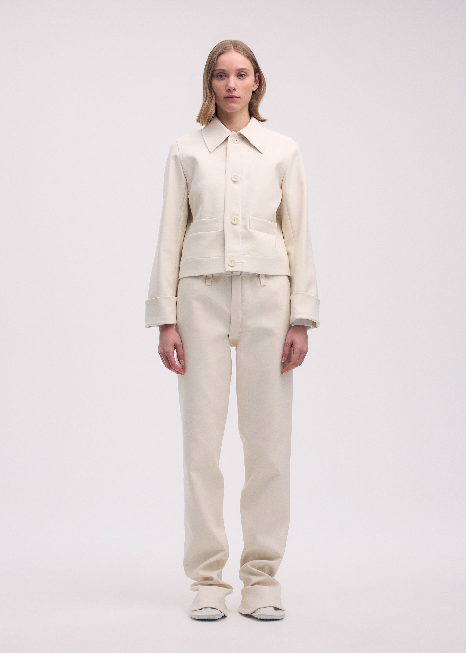 A model wears the ISSEY MIYAKE GYPSUM jacket.