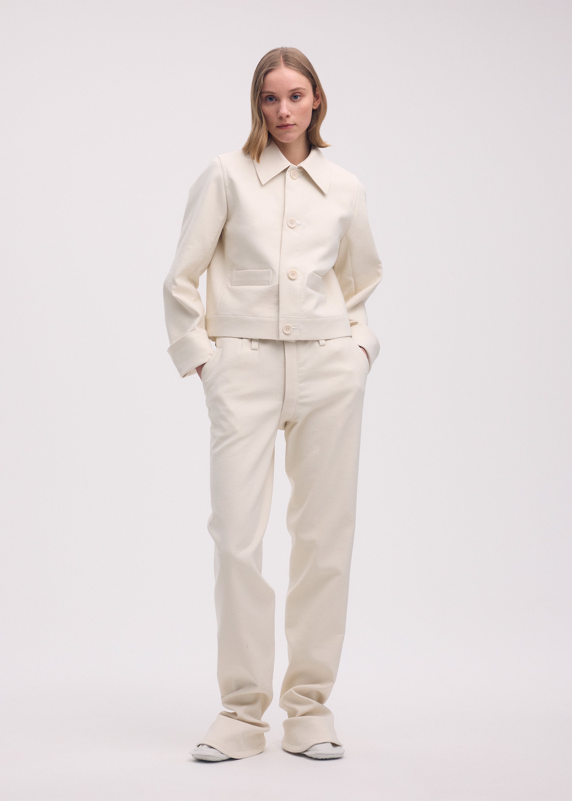A model wears the ISSEY MIYAKE GYPSUM jacket.