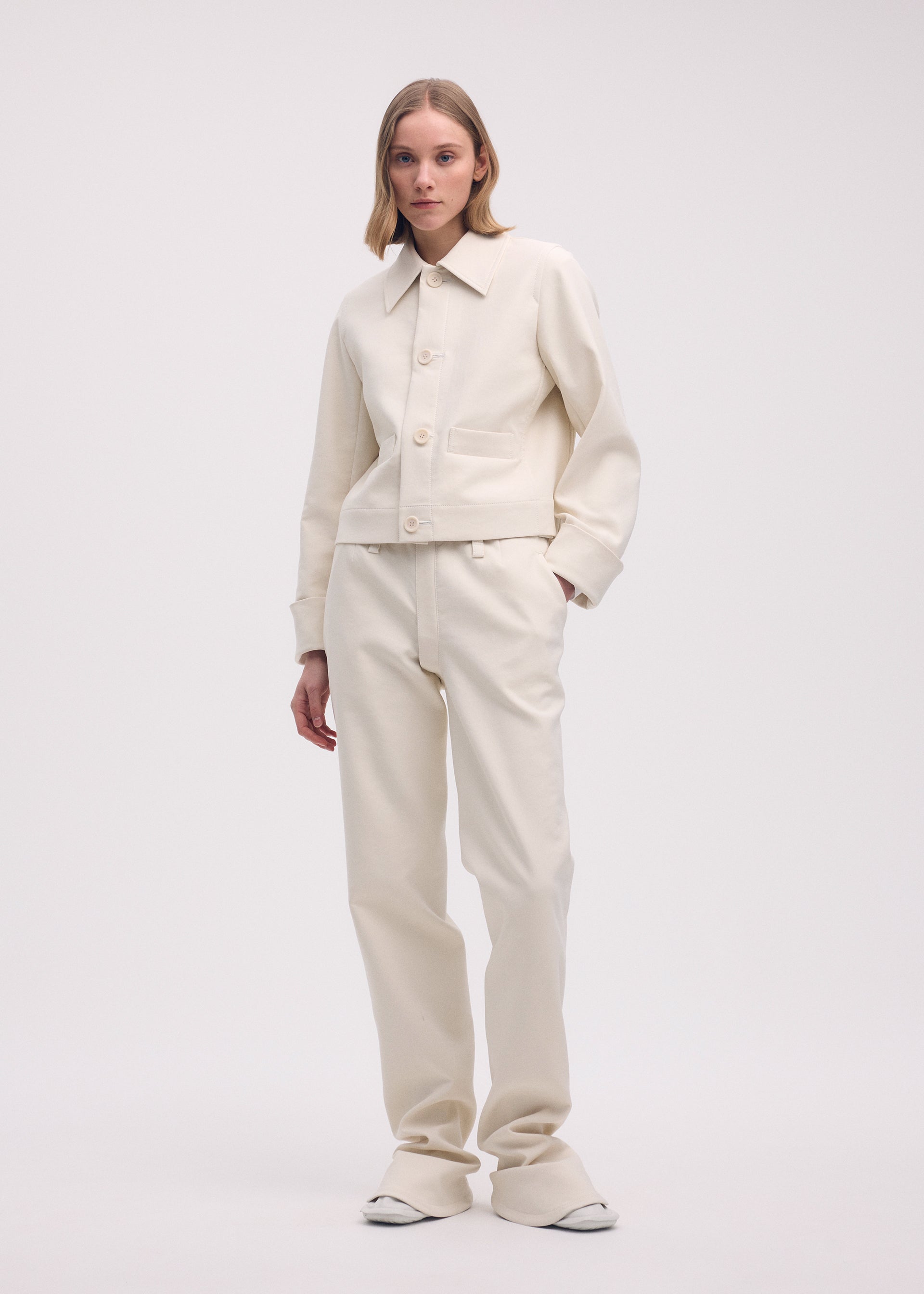A model wears the ISSEY MIYAKE GYPSUM jacket.