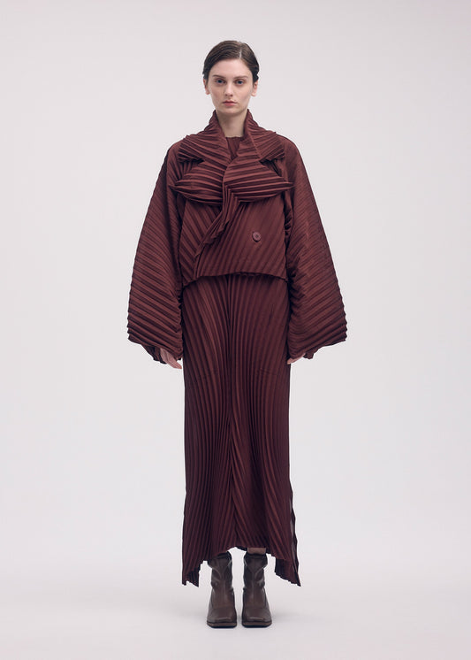 A model wears the ISSEY MIYAKE WAVE PLEATS jacket.