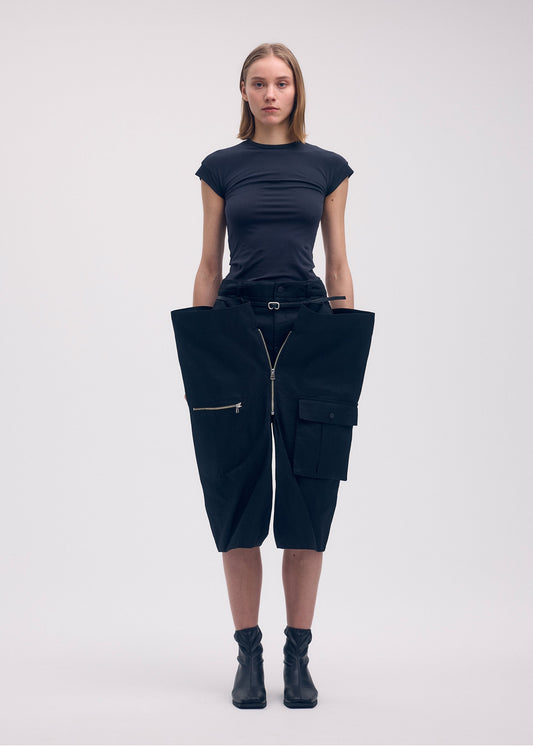 A model wears the ISSEY MIYAKE PEEKABOO trousers.