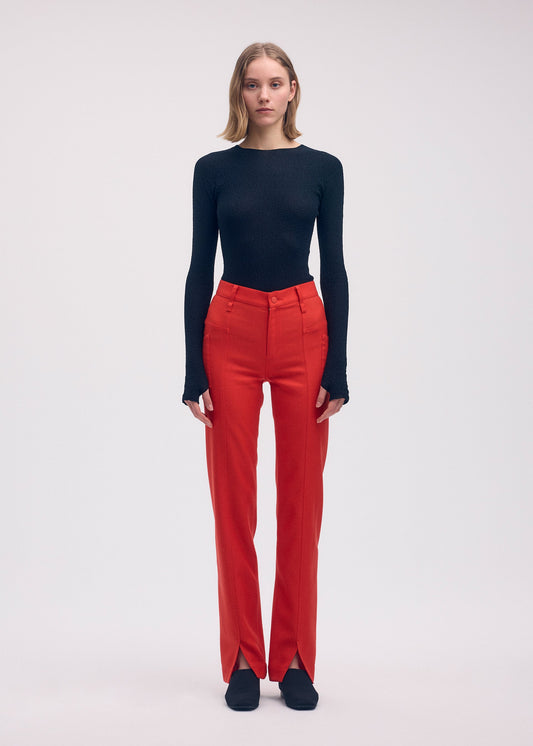 A model wears the ISSEY MIYAKE DISPOCKET PANTS trousers.