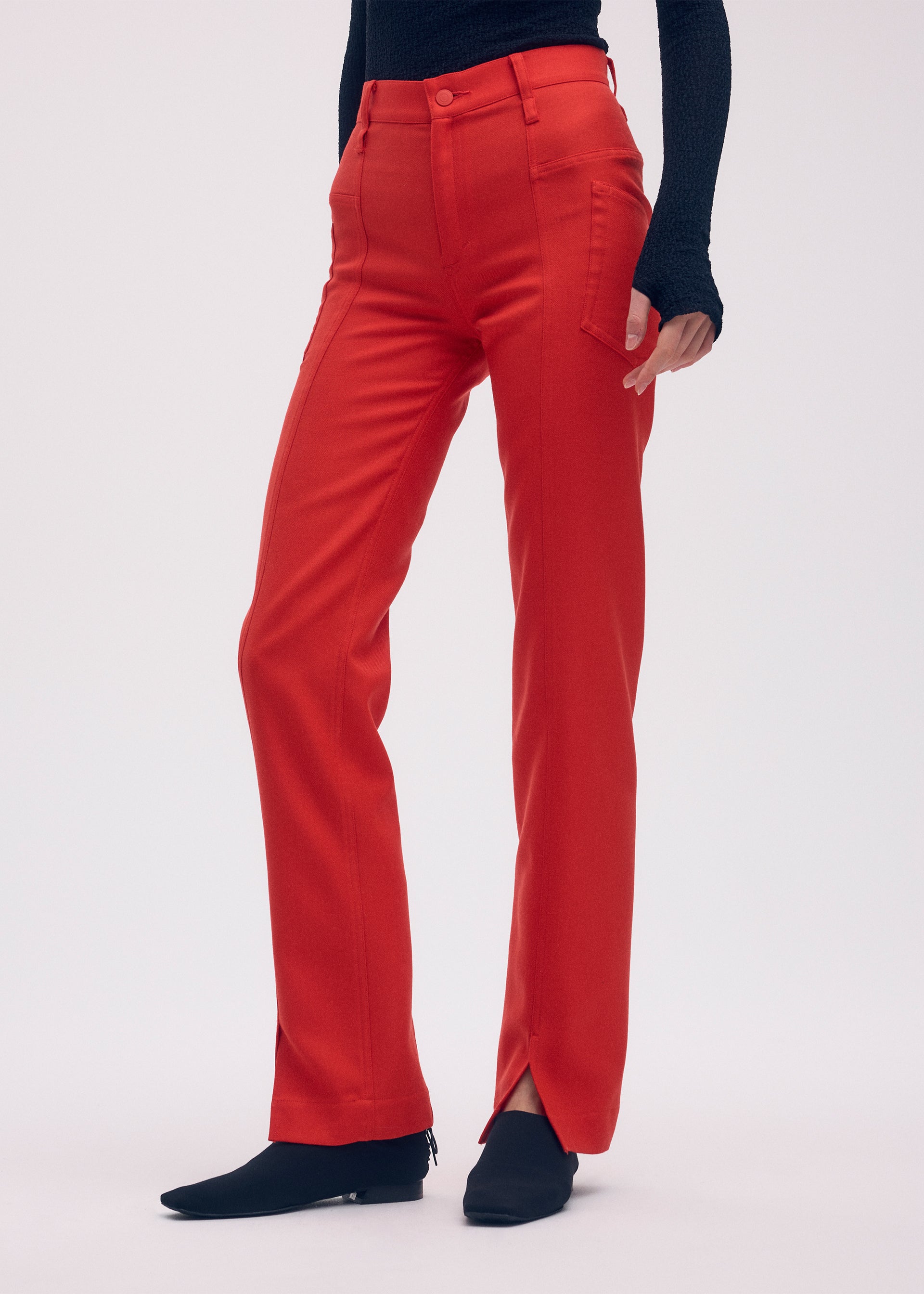 A model wears the ISSEY MIYAKE DISPOCKET PANTS trousers.