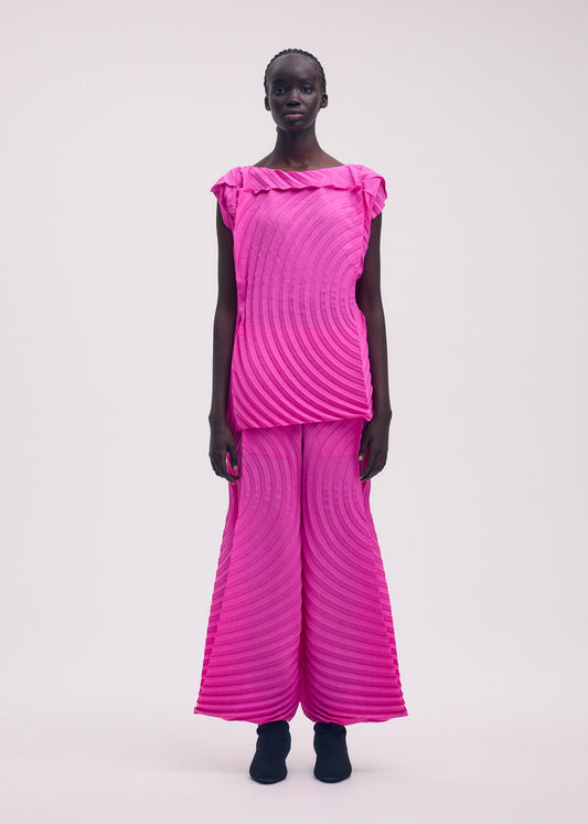 A model wears the ISSEY MIYAKE PAPER BAG PLEATS trousers.