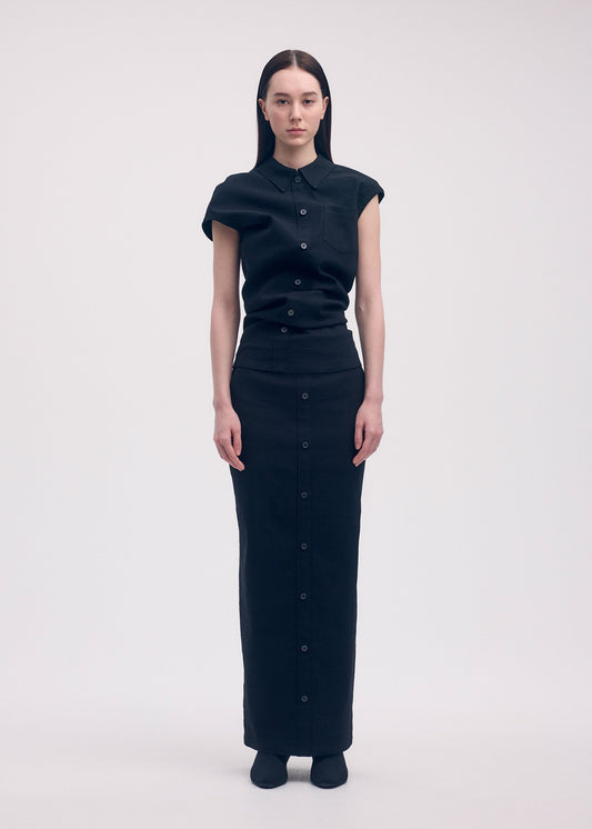 A model wears the ISSEY MIYAKE LIKE TORSO LIKE SHIRT skirt.