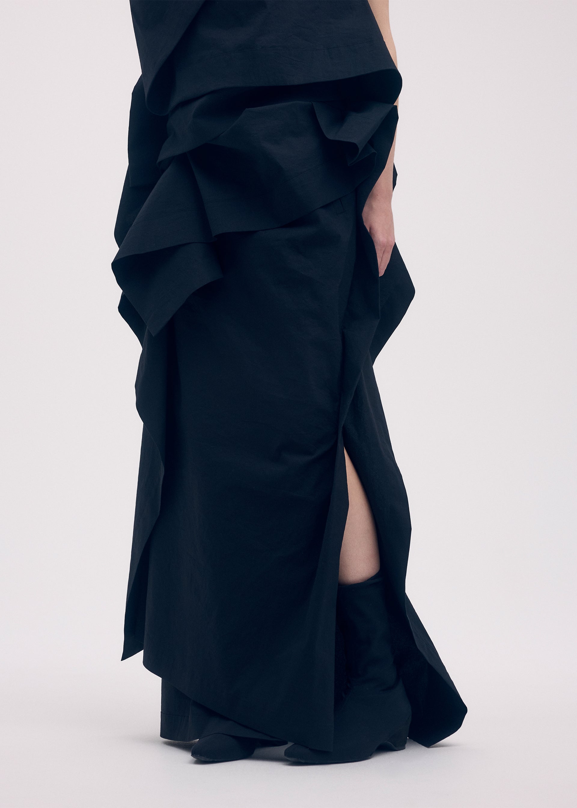 A model wears the ISSEY MIYAKE COLLAPSING SCULPTURE skirt.