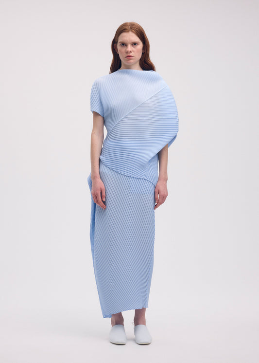A model wears the ISSEY MIYAKE SOFT FOLD PLEATS skirt.
