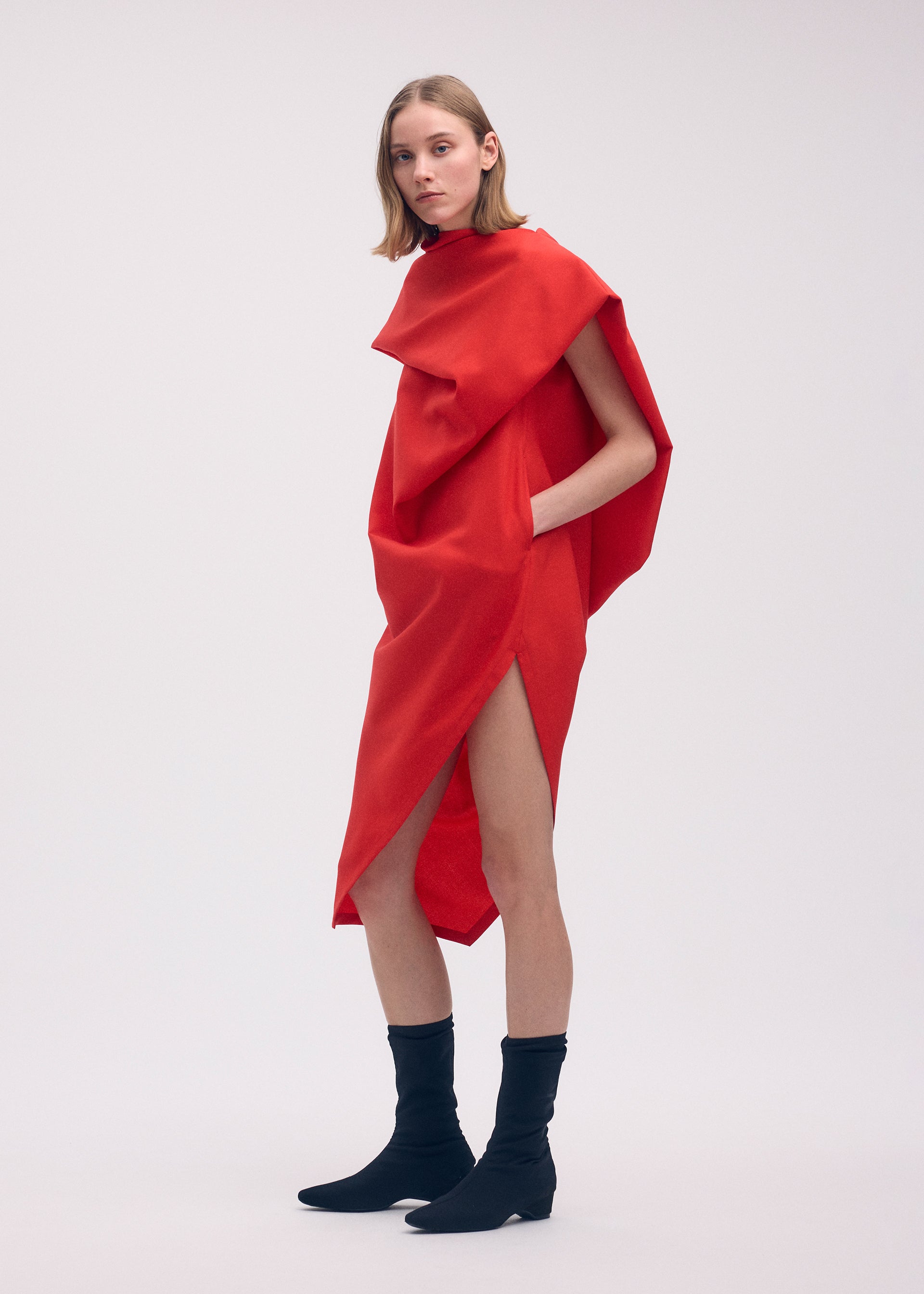 A model wears the ISSEY MIYAKE UNI FORM (WOOL) dress.