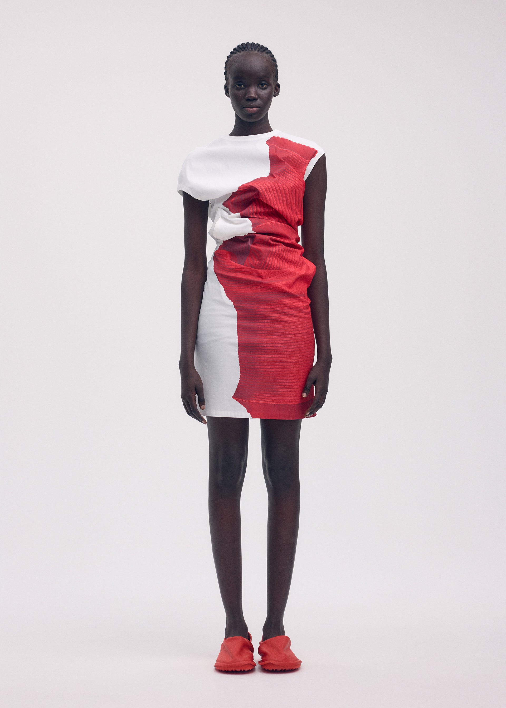 A model wears the ISSEY MIYAKE KNIT (AS REPRESENTED) dress.
