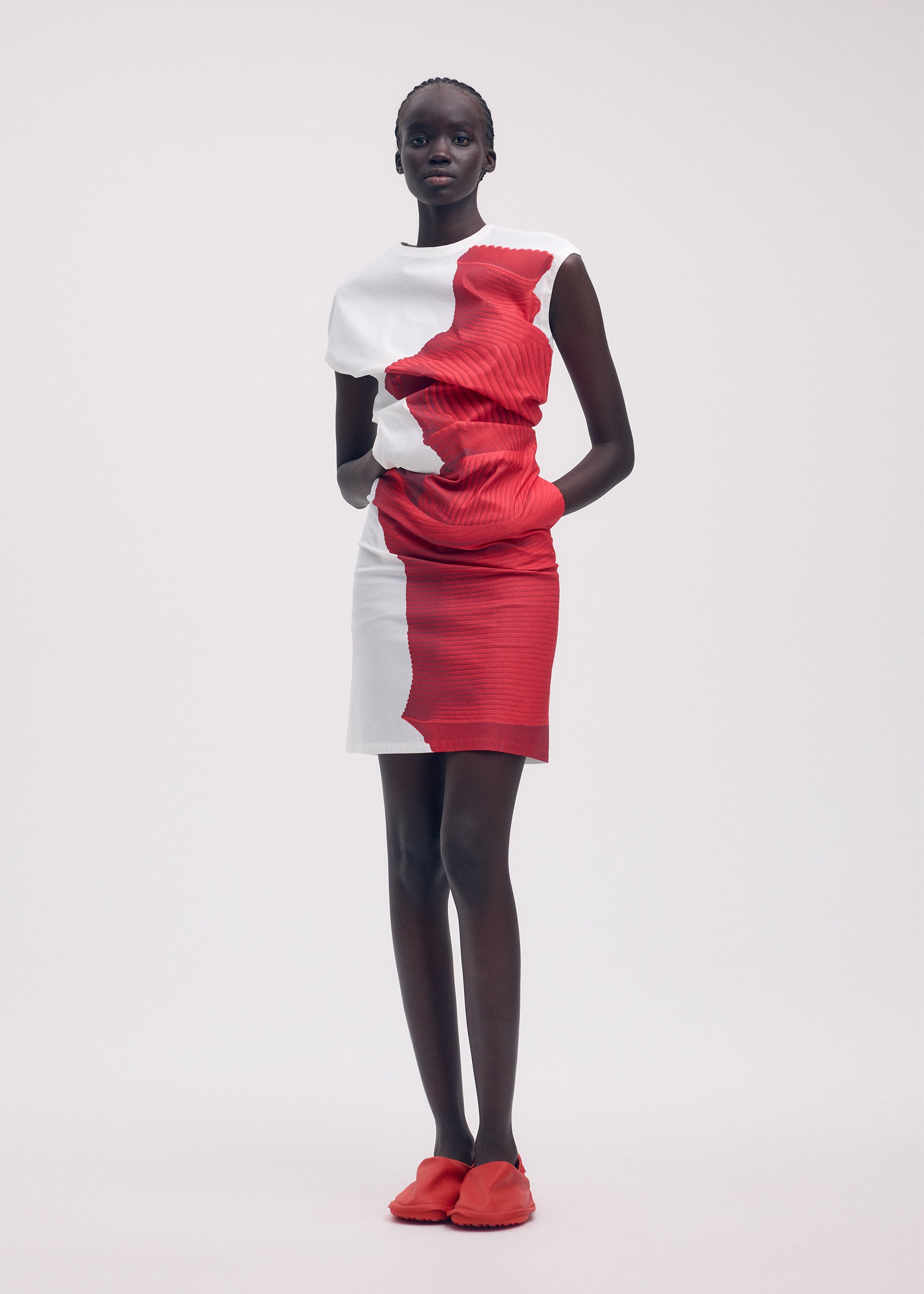 A model wears the ISSEY MIYAKE KNIT (AS REPRESENTED) dress.