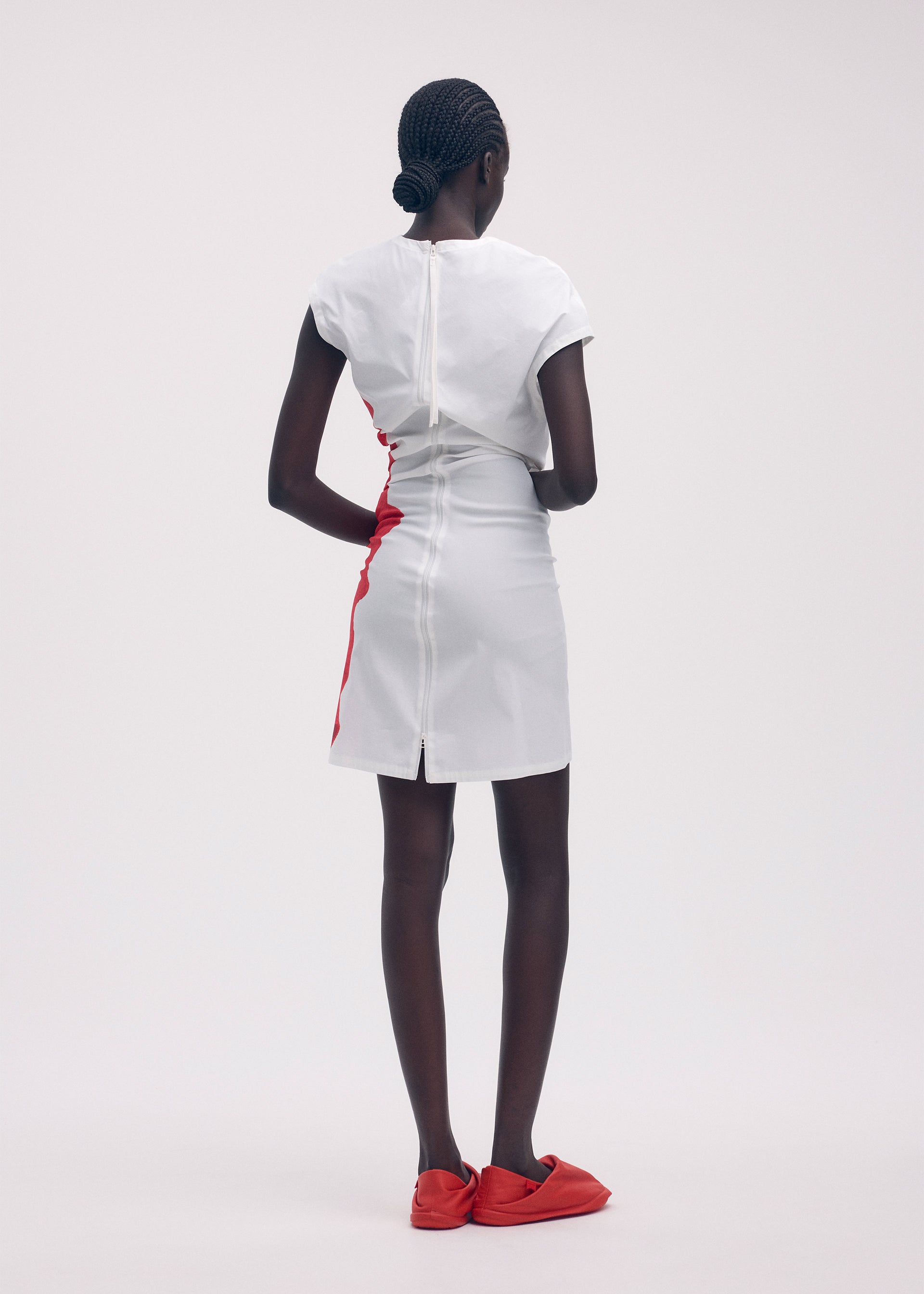 A model wears the ISSEY MIYAKE KNIT (AS REPRESENTED) dress.