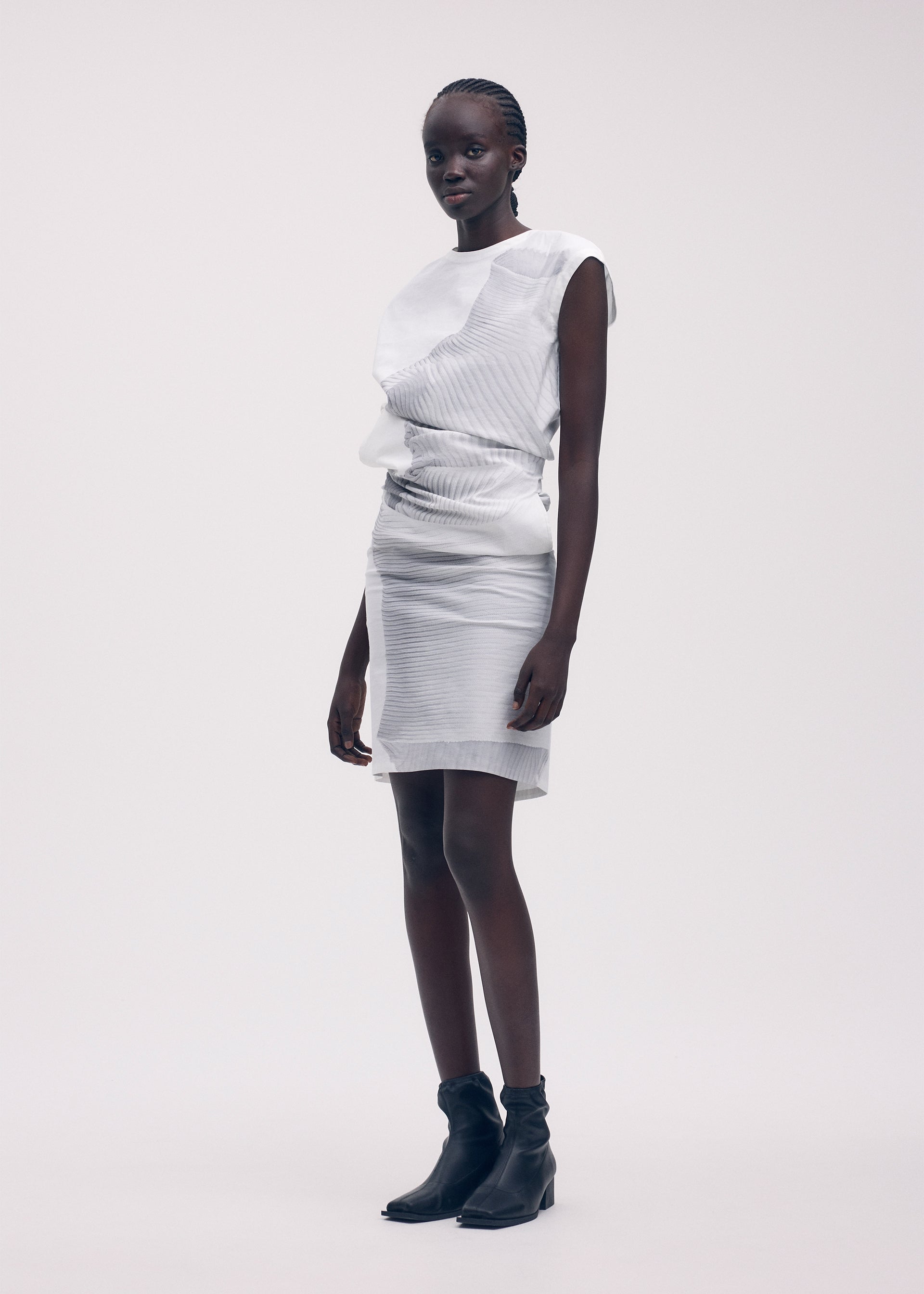 A model wears the ISSEY MIYAKE KNIT (AS REPRESENTED) dress.