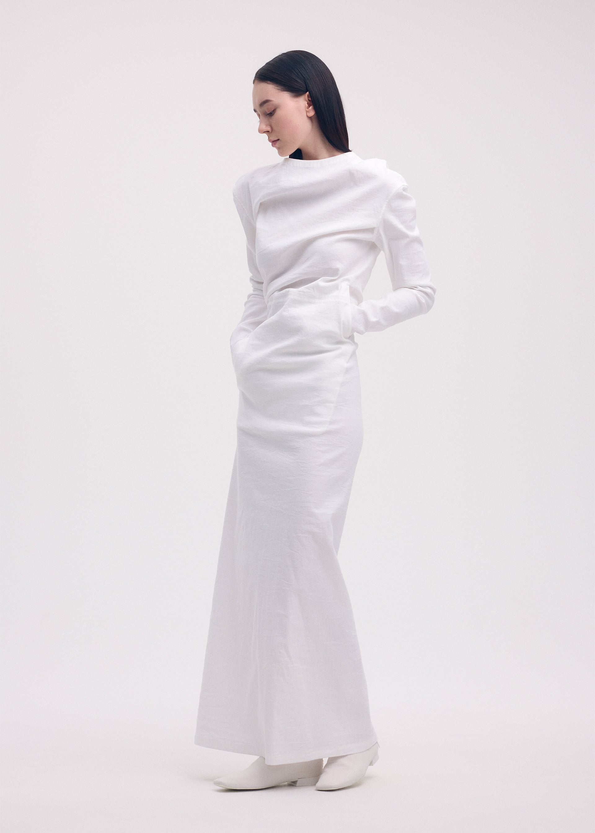 A model wears the ISSEY MIYAKE LIKE TORSO LIKE SHIRT dress.