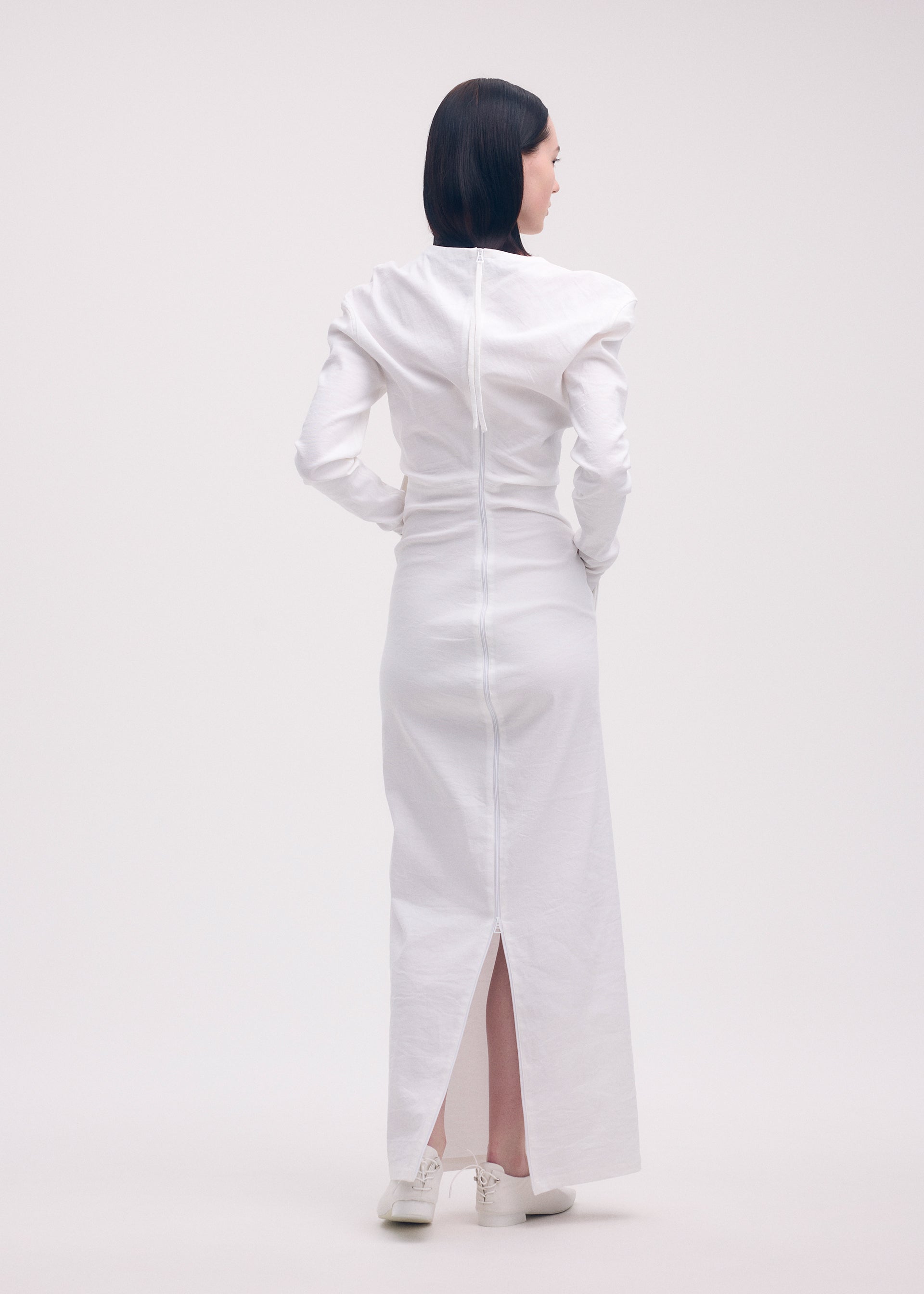 A model wears the ISSEY MIYAKE LIKE TORSO LIKE SHIRT dress.